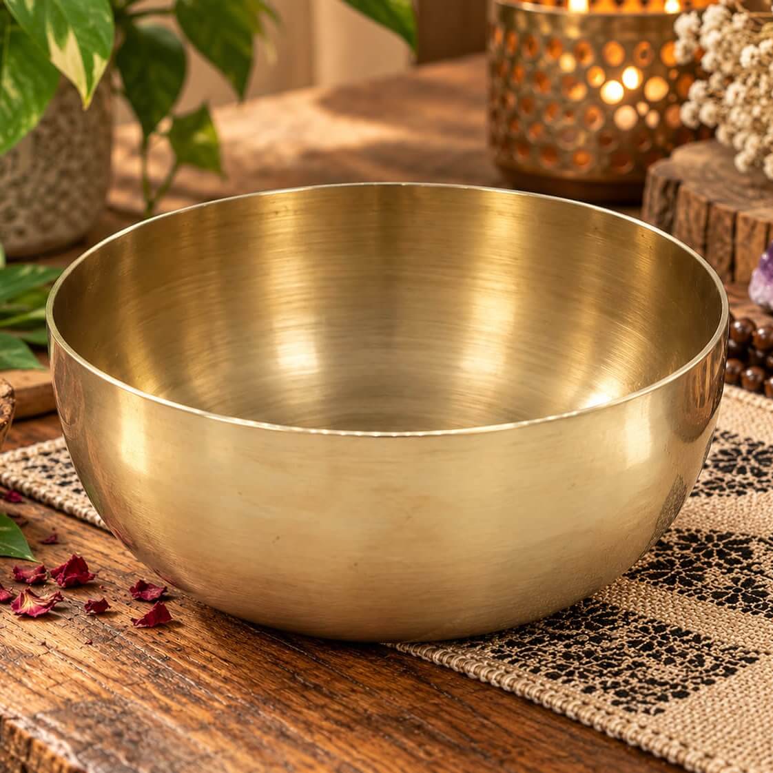 Bol chantant tibétain en laiton lisse de 17 cm posé sur une table en bois