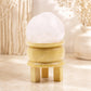 Boule de cristal de roche transparente posée sur son support tripode en bois