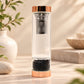 Bouteille à thé en verre avec finition or rose, infuseur inox et éclats d'onyx noir à la base