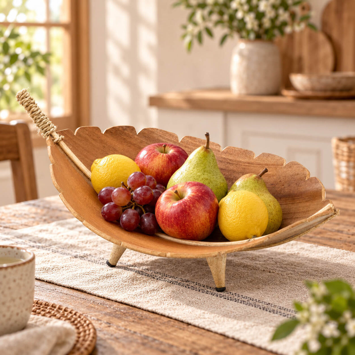 Coupe à fruits en feuille de coco garnie de pommes, poires, citrons et raisins