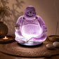 Lampe Bouddha rieur lavande craquelée allumée dans une ambiance zen aux encens.