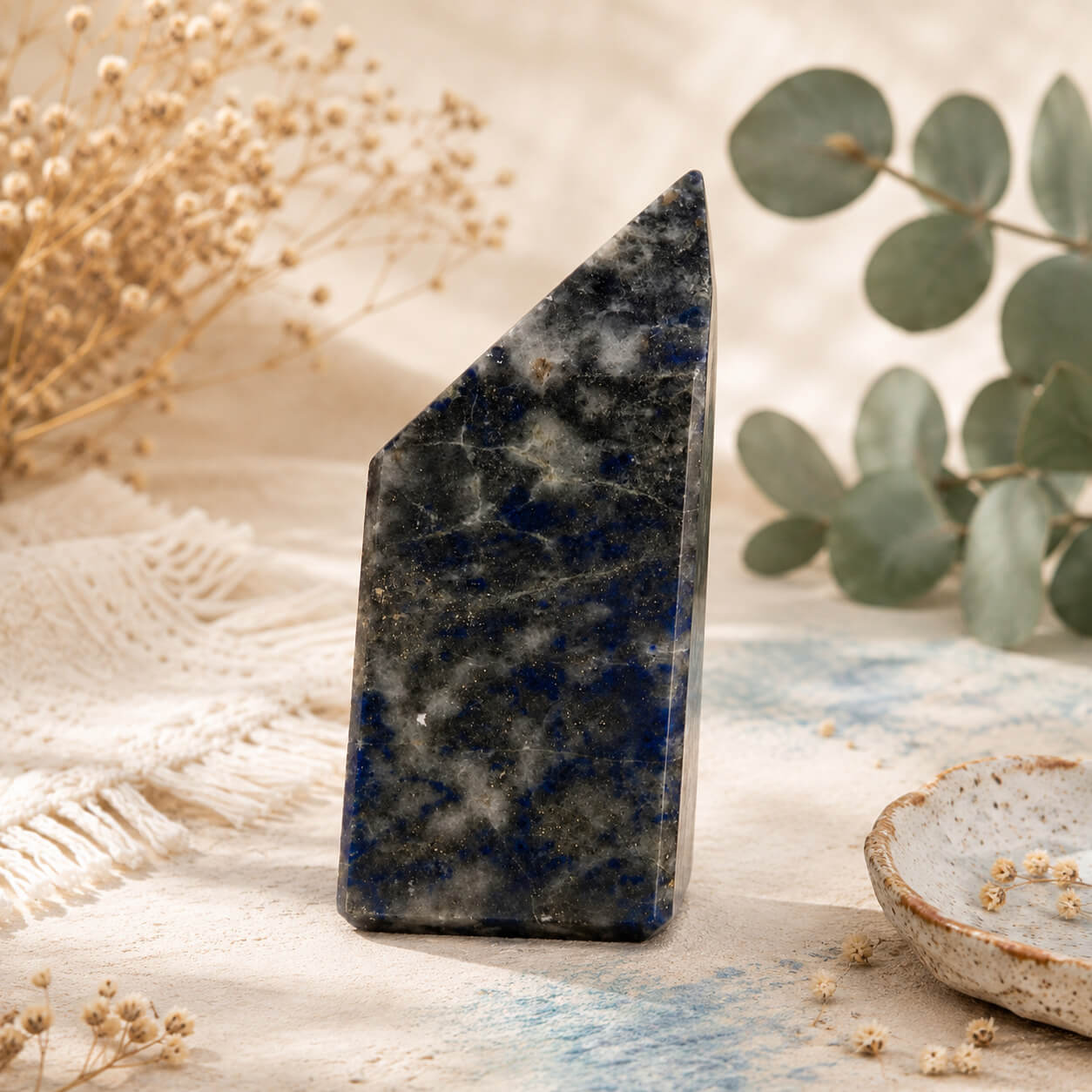 Pointe de lapis-lazuli polie aux veines bleu profond posée debout