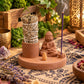 Porte-encens Bouddha en céramique garni d'un bâton de sauge, d'un cône et d'un bâtonnet d'encens violet allumé