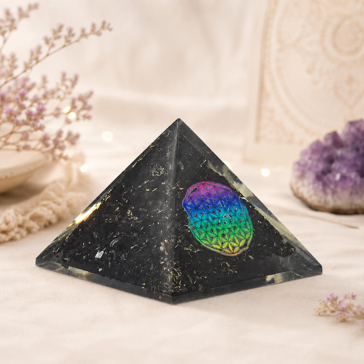 Pyramide en orgonite noire avec médaillon Fleur de Vie multicolore et éclats de tourmaline