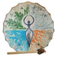 Tambour chamanique décoré d'une silhouette méditative entourée de motifs représentant l'eau, le feu, l'air et la terre.