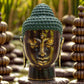 Tête de Bouddha en laiton à la coiffe turquoise patinée et au visage bronze antique, expression sereine.